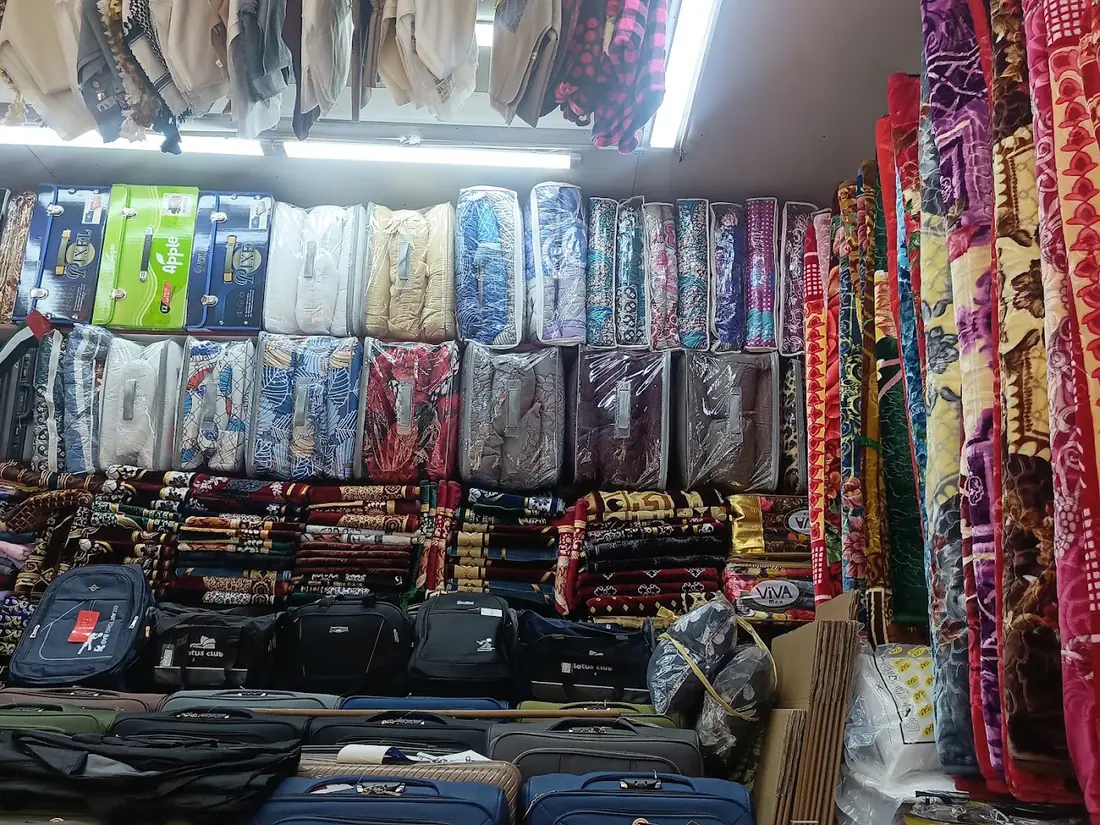 Blankets and trolley bags stacked in the shop