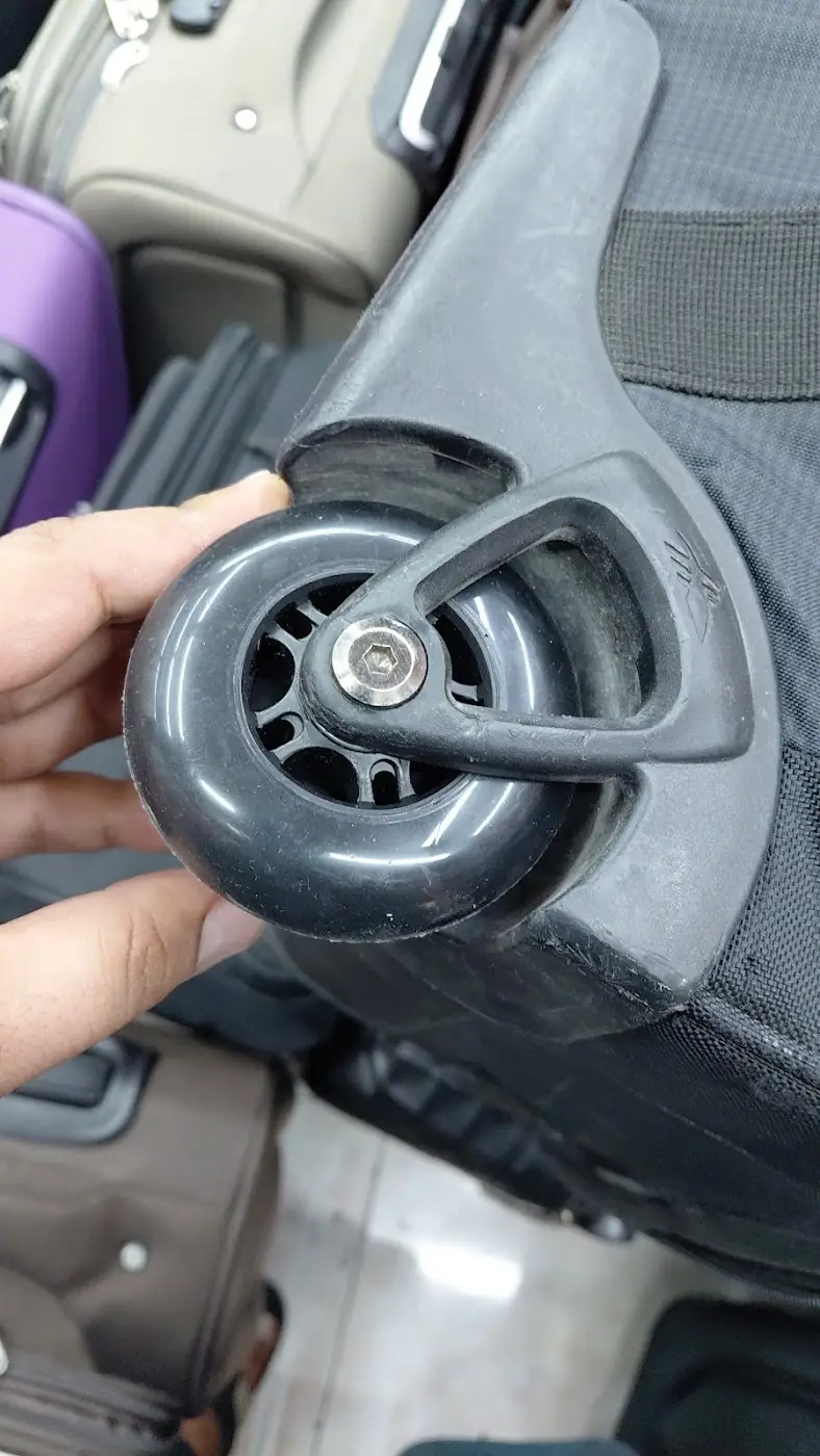 A suitcase wheel being replaced at Al Amwaj Footwear
